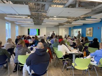 The group listening to the day’s keynote speaker on communications in the Community Room. Courtesy of BRYMCA