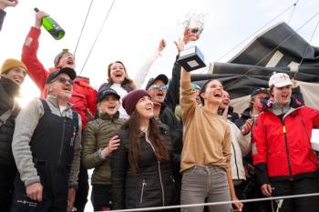 Cole Brauer triumphantly raises her trophy after placing second in the Global Solo Challenge. Alvaro Sanchis photo