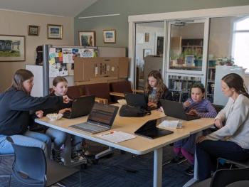 Girls Who Code, from left, Camille Ross, facilitator; Jacqueline Branch, coding a Travis Kelce-Taylor Swift Pong game; Emma Scott, coding a basketball game; Kinsley Weiss, coding a choose-your-own-adventure story; and Bethany Schmidt, facilitator. CANDI JONETH/Boothbay Register