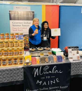 Cherie Scott, right, holds her award at the 40th annual New England Made Giftware & Specialty Food Show. Courtesy of Cherie Scott
