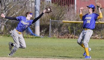 Seahawk Sam Markowitz reaches for a catch as teammate Casey Phelps moves out of the way at the game against Mt. View May 10. FRITZ FREUDENBERGER/Boothbay Register