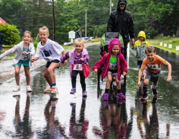 Unfazed by the rain, a group of younger runners start off at a sprint during the kids’ leg of the Edgecomb 250th Birthday Road Race on June 22. The family friendly event catered to all ages and several racers even walked or ran the course with strollers. Bisi Cameron Yee photo