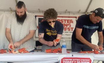 Contestants compete June 26 in the Windjammer Days lobster eating contest. Craig Browning of Newcastle, Australia, right, won in 100 seconds. BILL PEARSON/Boothbay Register