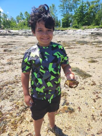 Boothbay Region Elementary School student Jimmy Hourihan holds up a salty friend. Courtesy of Jennifer Lassen