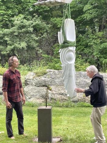 Chris Lewis, left, and Bill Royall prepare to set “Seed” on its base. Courtesy of Diana Kerr
