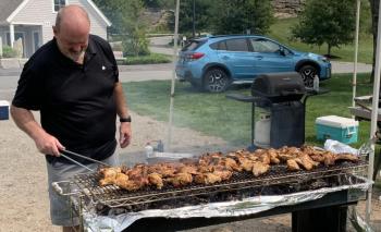 Volunteer Brad Drummond carefully watches barbecue chicken baking Aug. 17 during the annual V.E.T.S. Inc. fundraiser at Boothbay Common. BILL PEARSON/Boothbay Register