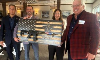 Philanthropist Paul Coulombe, right, receives a unique gift Aug. 15 during a benefit for the Special Operators Transition Foundation. The non-profit group assists miliary special operators transitioning from soldiering into executive business positions. The event was held at Boothbay Harbor Oceanside Golf Resort. Pictured, from left, SOTF CEO Austin Moore, SOTF Director of Development and Corporate Engagement Bobby Payne, and SOTF Operations Coordinator Angie Arias. BILL PEARSON/Boothbay Register