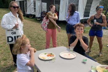 Frankie Moran, 5, and Paxton Turpin, 8, right, enjoy a hot dog Aug. 16 at Boothbay Sea and Science Center’s Aug. 16 “Last Day of Camp” barbecue. BILL PEARSON/Boothbay Register