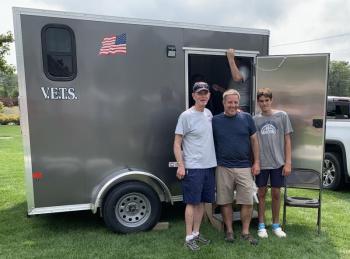 V.E.T.S. Inc. volunteer Chris Goodwin shares a moment with barbecue participants Dave Sirois, middle, and Eli Sirios. BILL PEARSON/Boothbay Register