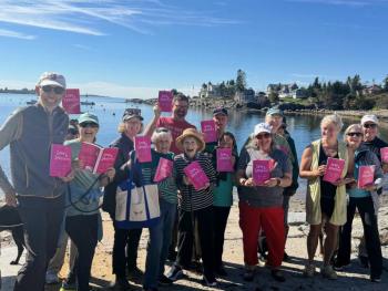 A group of people show of their copies of Love & Lobsters