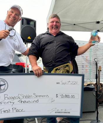 Tuna Challenge committee member Andrew Morley, left, presents Roger Simmons awards for winning the 2024 Boothbay Harbor Tuna Challenge. Simmons won the tournament alongside his son, Shelden. Courtesy of Boothbay Harbor Tuna Challenge