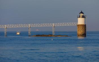 As seen last year - A now historic view, as a result of the January storms, of the Cuckolds light station in the distance along with a lobster boat nicely framed up by the support stanchions under the catwalk. Mike Leonard photo