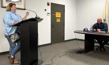 A woman talks to the town board