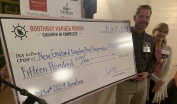 Bristol Marine Founder and Co-owner Andy Tyska and Chamber President Julie Roberts presents a $1,500 donation to the New England Wooden Boat Preservation Fund during the ceremony. BILL PEARSON/Boothbay Register big check