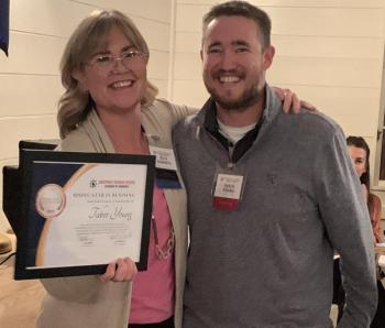 Chamber President Julie Roberts presents Tabor Young with the Rising Star in Business. BILL PEARSON/Boothbay Register young guy