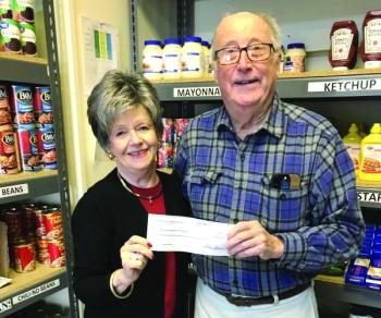 Fleet Davies accepts a $1,295 check on behalf of the Boothbay Region Food Pantry from Sarah Seepe of the Boothbay Region Mah Jongg group. William Seepe photo