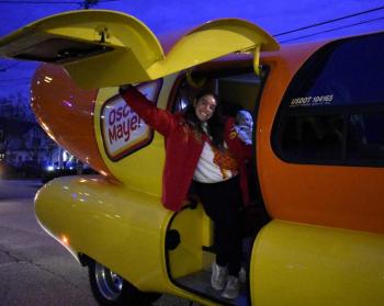 The Wienermobile and one of the drivers