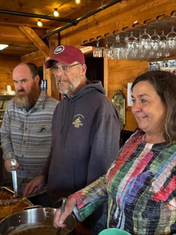 Darrell Gudroe, left, Steve Edwards and Lisa Hallinan serve the food at the Dec. 2 Community Lunch. Jen Mitchell photo