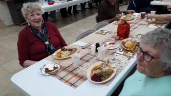 Penny Donovan, left, and Boothbay neighbor Freda Burnham share Thanksgiving dinner. JANE CARPENTER/Boothbay Register Penny Donoval and Freda Burnham