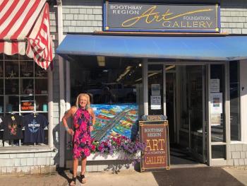 Sandra Chase Morrissey stands in front of her painting in a window at BRAF in 2022. FB photo Sandra Chase Morrissey stands in front of her painting in a window at BRAF in 2022. FB photo