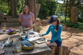 Children work with watercolor paints during a summer camp. Courtesy of CMBG