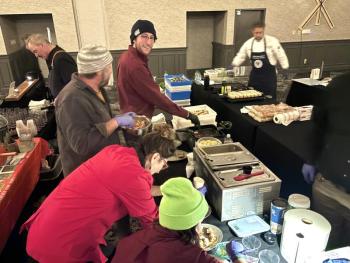 Lori Mitchell (in red) and the crew of Boothbay Craft Brewery whip together 400 lobster bites. Courtesy of Lori Mitchell