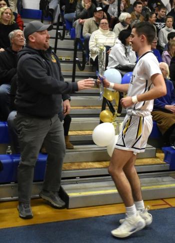 Aidric Canada presents his carnation to his father, Kyle Canada. BOOTHBAY REGISTER/Fritz Freudenberger
