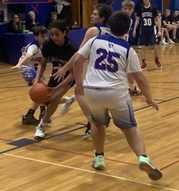 Boothbay Wildcat Malachi Donaldson drives by three Great Salt Bay defenders Feb. 5 in the Busline League Small Conference basketball championship game in Damariscotta. BILL PEARSON/Boothbay Register BRES