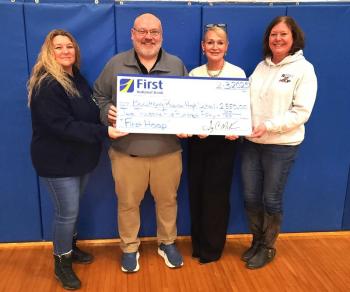 First National Bank presenting Boothbay Region High School with a check for $2,550 from the First Hoop program. Courtesy photo