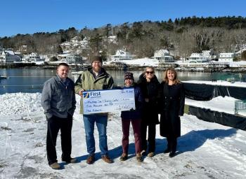 From L: First National Bank’s Dan Hallinan and Adam Climo, Boothbay Sea and Science Center’s Pauline Dion, First National Bank’s Alyssa Allen and Nicci Kimball presenting a check for $5,000 toward rebuilding the pier project. Courtesy of First National Bank