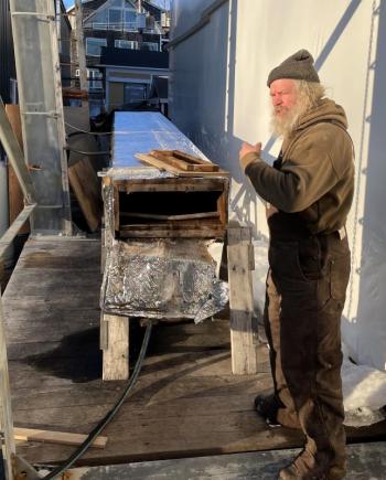 Tom Gerhard shows off a steam box used to make wooden planking pliable enough to put on the ship. FRITZ FREUDENBERGER/Boothbay Register