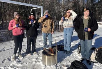 Lincoln Academy students enjoy the hot cocoa they prepared after building a fire. Courtesy of Shannon Parker