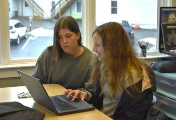 Club co-facilitator Camille Ross and Emma Scott review Scott's animation created using block-coding. ISABELLE CURTIS/Boothbay Register