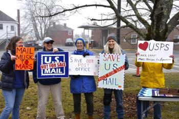 The weather may have been dreary but that didn't stop protestors from gathering to challenge the possible privatization of the USPS. ISABELLE CURTIS/Boothbay Register