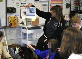 Michelle Rancourt of Midcoast Humane reads to students about Maggie the shelter dog. ISABELLE CURTIS/Boothbay Register