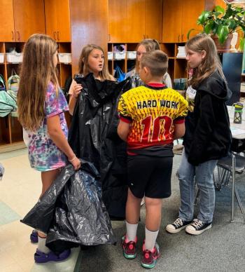 EES students discuss particular assignments on their recycled “paper route.”  Hattie, daughter of Nellie Brylewski and Simon Tomko;  Briar, daughter of Arianna and Brice Johnson;  Azalea, daughter of Laurel and Max Averill;  Bryson, son of Melissa and Joseph Hersom;  and Isabel, daughter of Cashel and Brian Fanslau.  Students are residents of Alna and Edgecomb. Courtesy photo