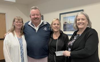 L- R: Angela Robinson, Director of Waiver Services, Mobius,  Mike and Sue Risinger, and Mobius Executive Director Michaela York, who accepted the donation on behalf of Mobius in memory of Kylee Risinger Turcotte. Courtesy of Eleanor Busby