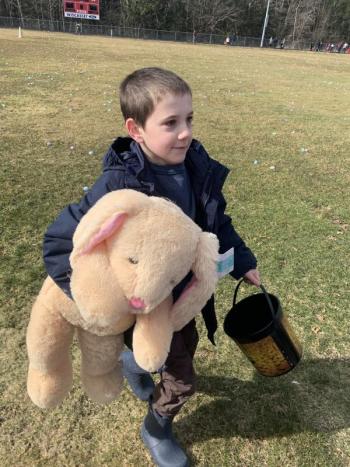 Wiscasset’s Sam Renzi, then 8, returns to his family after winning a stuffed bunny at last year’s Easter egg hunt at the Wiscasset Middle High School track. File photo 