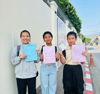 Thai Daughters Yuki, Prem, and Katang with their visas. Courtesy of Ellen James, FTD