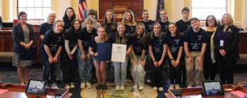 Sen. Cameron Reny, D-Bristol, left, and Rep. Holly Stover, D-Boothbay, right, stand with the Boothbay Region High School Drama Club and their legislative sentiment in the Senate chamber before session on April 29. Courtesy photo