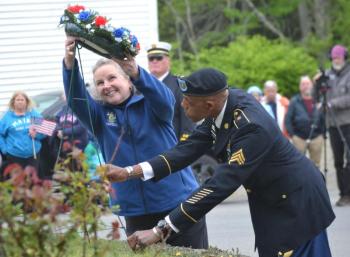 2024 Memorial Day Grand Marshal Sarah Sherman and Legion Post #36 Americanism Officer Christopher Armstead place a wreath at the Southport memorial. File photo