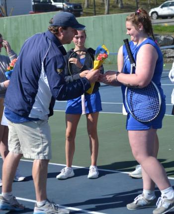 Seahawk coach Alex Arsenault presents flowers to senior Ivory Cody on senior day. KEVIN BURNHAM/Boothbay Register