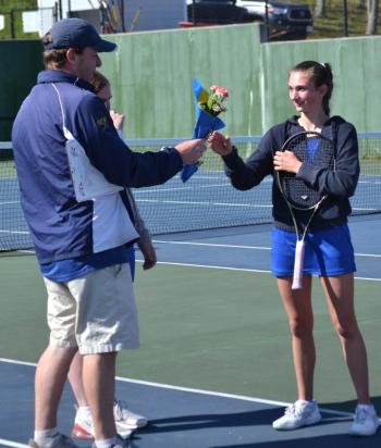 Seahawk coach Alex Arsenault presents flowers to senior Laura Chapman on senior day May 14. KEVIN BURNHAM/Boothbay Register