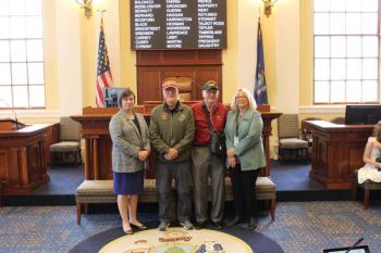 Sen. Cameron Reny, D-Bristol, left, and Rep. Holly Stover, D-Boothbay, right, stand with Phil Chapman and Jim Singer in the Senate Chamber before session on May 20. Courtesy photo