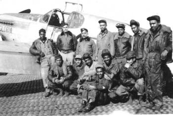 A group of Tuskegee airmen ground crew gather for a photo in front of the Gloria, a P-51 Mustang piloted by Flight Officer Thomas Lawson Hawkins. Courtesy of Bob Sheppard. A group of Tuskegee airmen ground crew gather for a photo in front of the Gloria, a P-51 Mustang piloted by Flight Officer Thomas Lawson Hawkins. Courtesy of Bob Sheppard.
