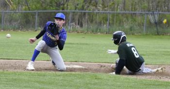Seahawk Sam Markowitz eyes the ball as a Spruce Mountain player comes on for a slide on third base May 20. FRITZ FREUDENBERGER/Boothbay Register