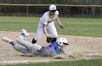 Sam Markowitz slides into first after attempting to steal against Maranacook May 13. FRITZ FREUDENBERGER/Boothbay Register