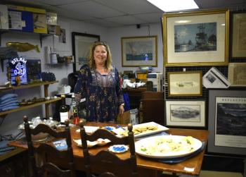 Laura de Haas of East Boothbay Trading Co., East Boothbay pauses for a "Kodak moment" during the June 6 First Friday.  LISA KRISTOFF/Boothbay Register