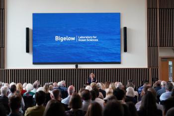 President and CEO Deborah Bronk speaking in the new Burgess Forum.