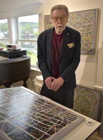 Terry Seaman, co-owner of Studio 53 discussing his latest work in memory of the Challenger crew. LISA KRISTOFF/Boothbay Register